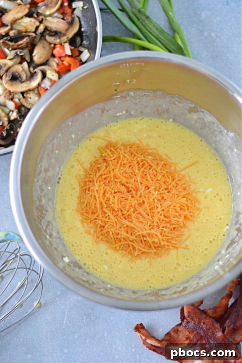 Mixing eggs, cottage cheese, and cheddar cheese in a bowl.