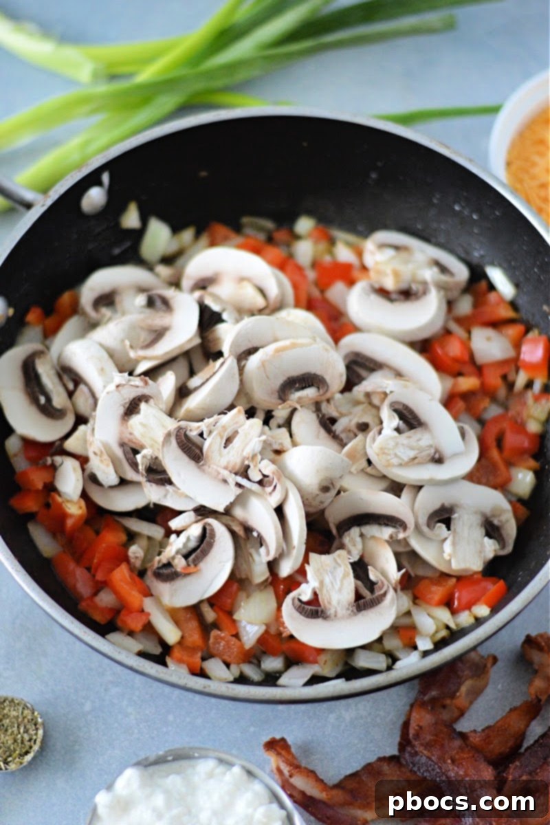 Adding raw veggies to the skillet.