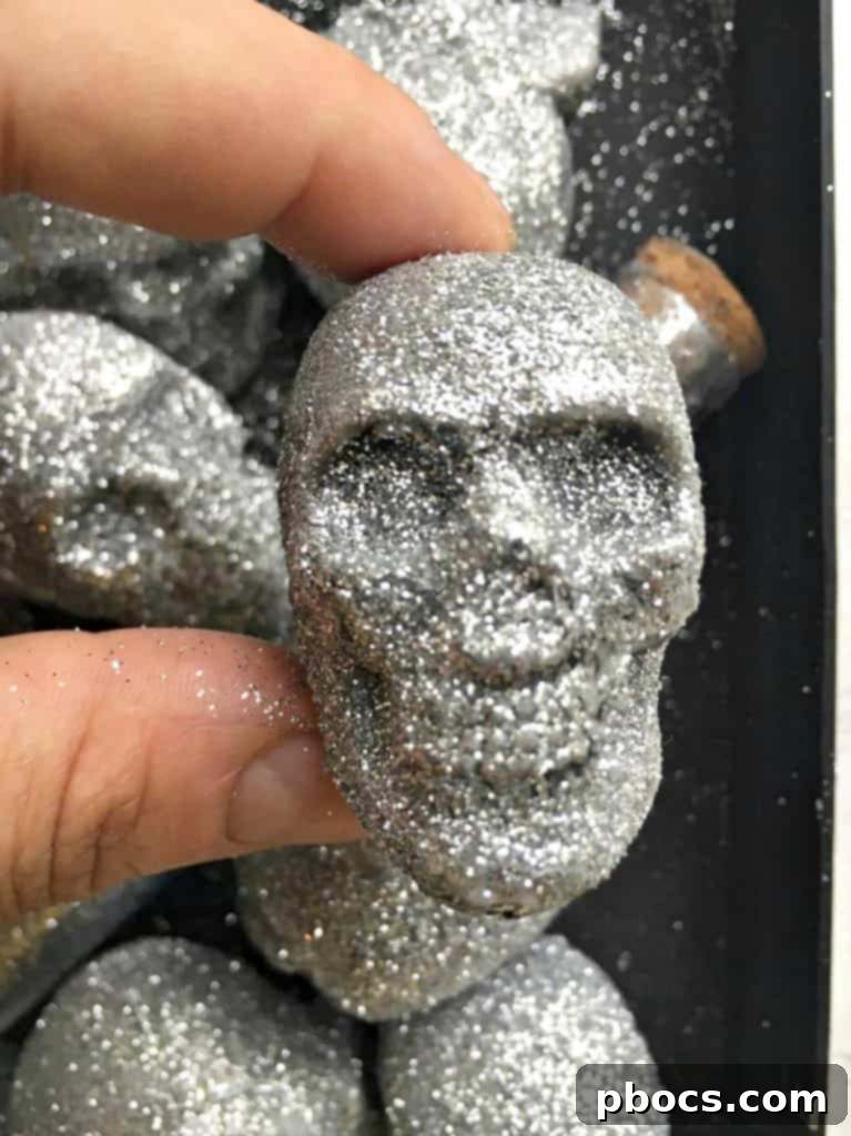 A glitter-covered skull being removed from a shoe box, sparkling brilliantly.