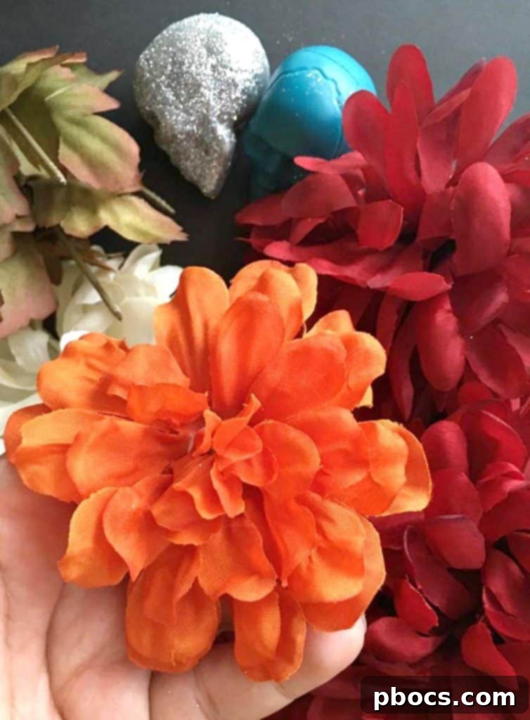 A collection of vibrant artificial flower heads, separated from their stems and ready for arrangement.