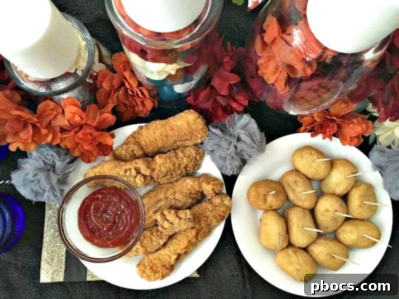 A festive close-up of the Dia de los Muertos party table, highlighting the food and colorful elements.