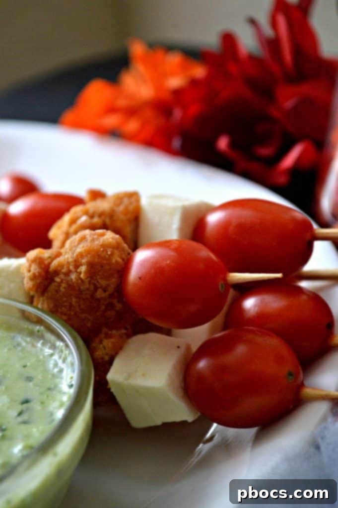 Close-up of a single chicken skewer, showcasing the alternating ingredients and the crispy chicken strip.