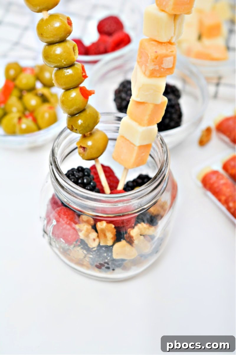 Adding fruit and nuts to the bottom of the mason jar.