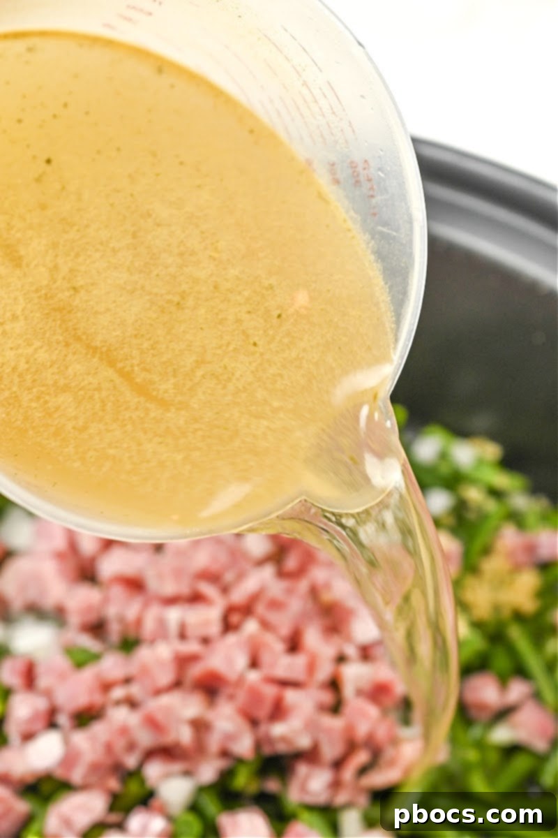 Hearty Keto Slow Cooker Ham and Green Beans 11 Adding chicken broth