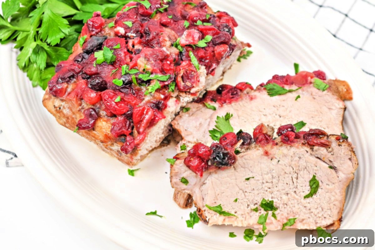 Closeup of Cranberry Pork Loin in a slow cooker, showcasing the vibrant sauce and tender meat.