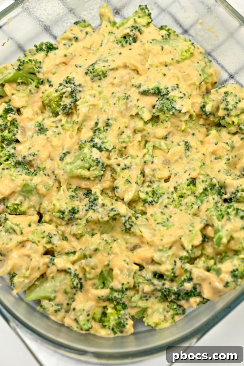 Cheesy broccoli mixture in a casserole dish before baking