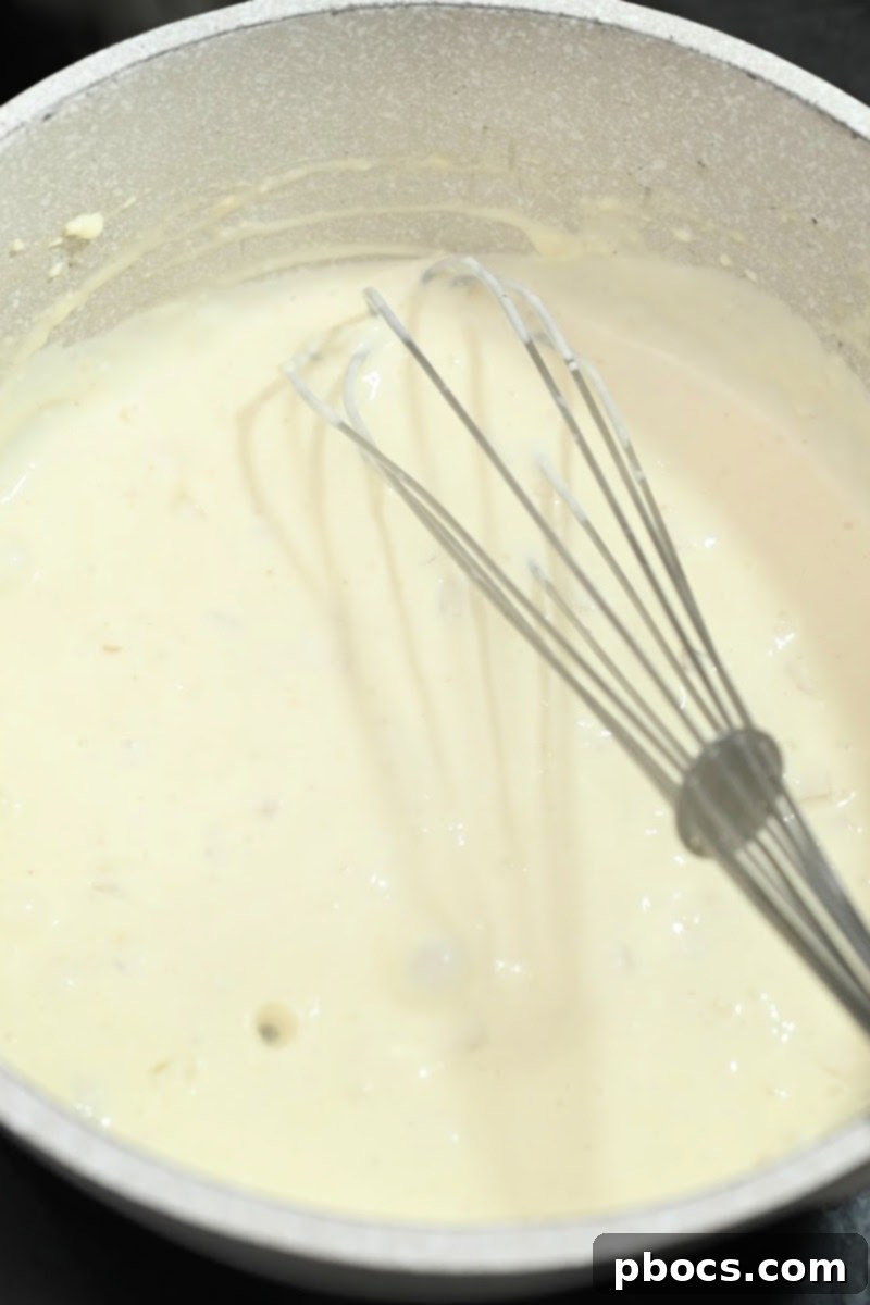 Making a creamy cheese sauce in a pot