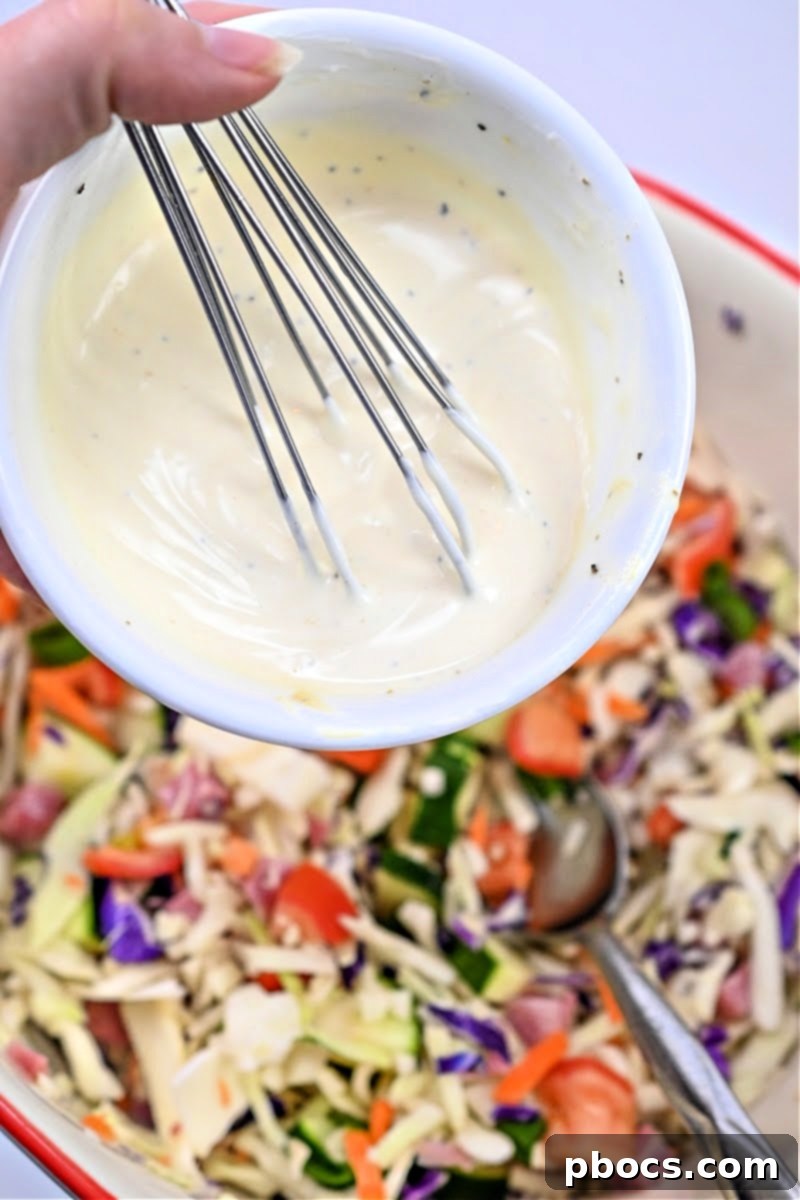 Adding the dressing to the salad