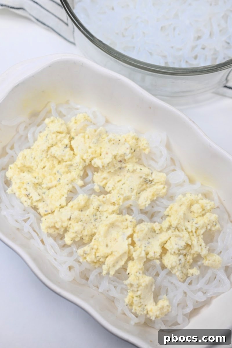 Keto Ramen Lasagna TikTok Style 10 Spreading ricotta cheese mixture over Miracle Noodles.