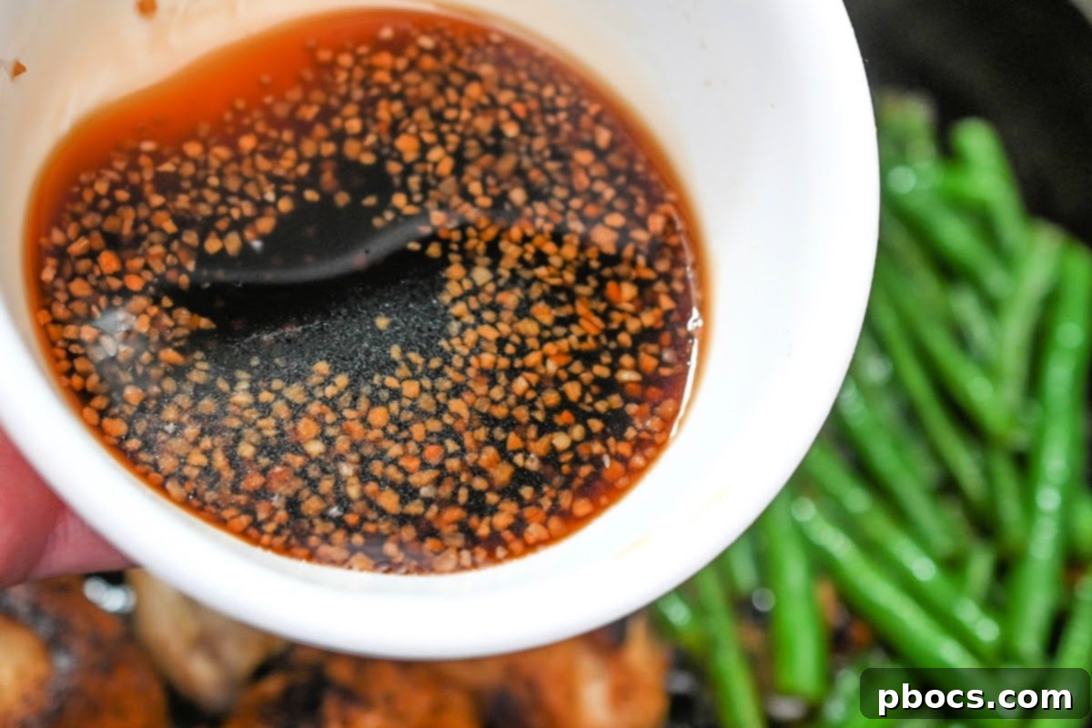 Keto Honey Garlic Chicken with Green Beans 11 Soy sauce, sugar-free honey, and minced garlic being whisked together in a bowl to create the sauce.