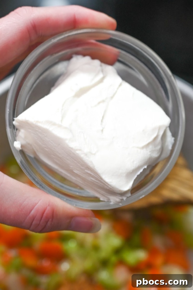 Keto Cajun Chicken and Shrimp Soup ingredients simmering in a pot