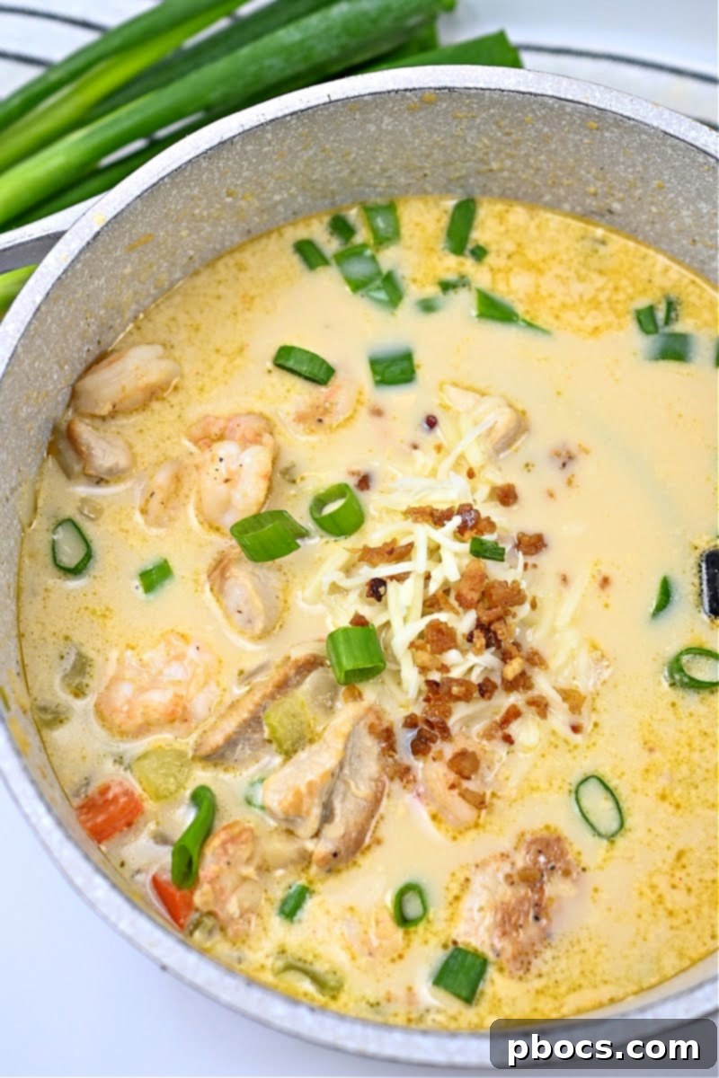 Close-up of Keto Cajun Chicken & Shrimp Soup with fresh parsley garnish