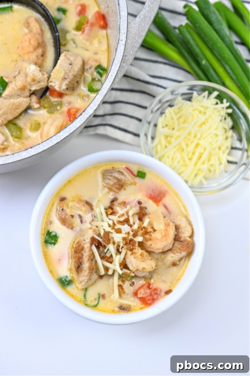 Bowl of Keto Cajun Chicken & Shrimp Soup on a rustic table