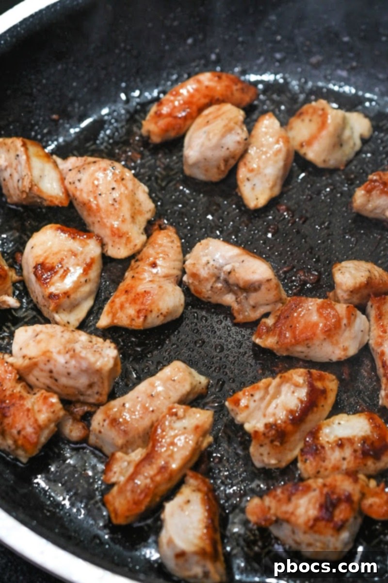 Cooking the seasoned chicken pieces in a skillet
