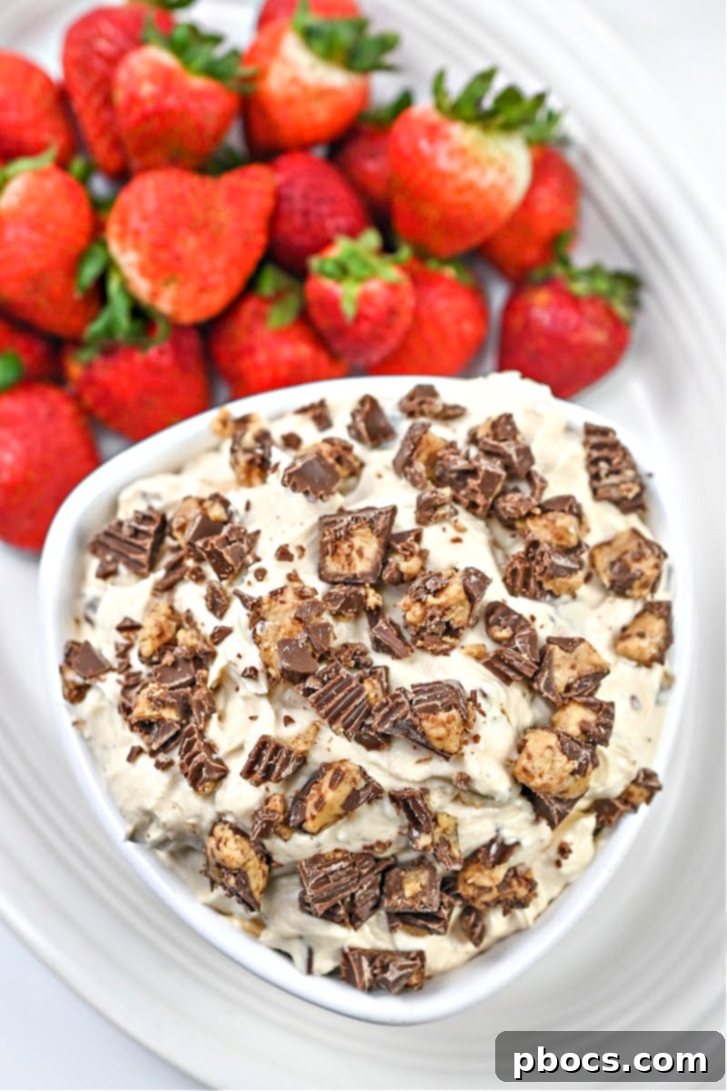 Keto Peanut Butter Chocolate Dip 5 Keto Reese's Dip presented in a stylish serving bowl, adorned with extra sugar-free peanut butter cup pieces, ready for a gathering