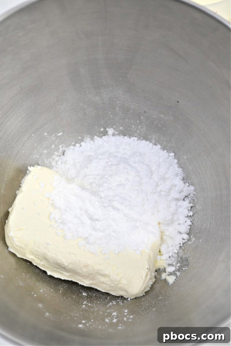 Keto Peanut Butter Chocolate Dip 8 Softened cream cheese and Swerve confectioners sugar substitute in a mixing bowl, ready to be blended