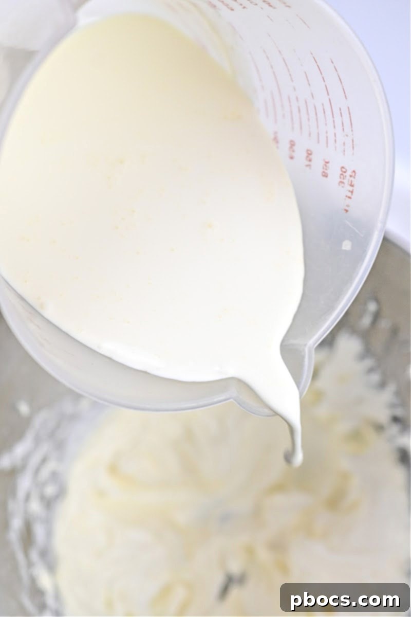 Keto Peanut Butter Chocolate Dip 9 Adding heavy whipping cream and vanilla extract to the cream cheese and sweetener mixture in a bowl