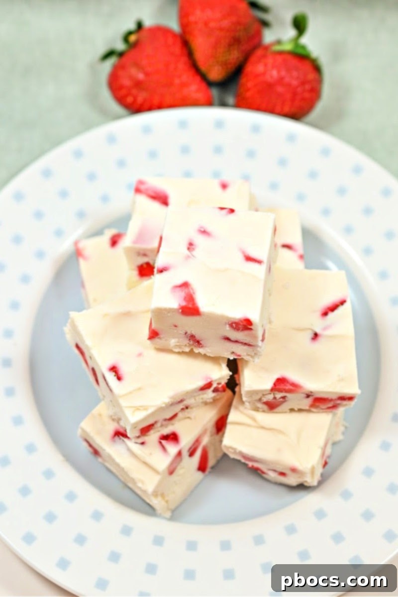 Decadent Keto Strawberry Fudge 4 A block of creamy Keto Strawberry Cream Fudge speckled with strawberry pieces