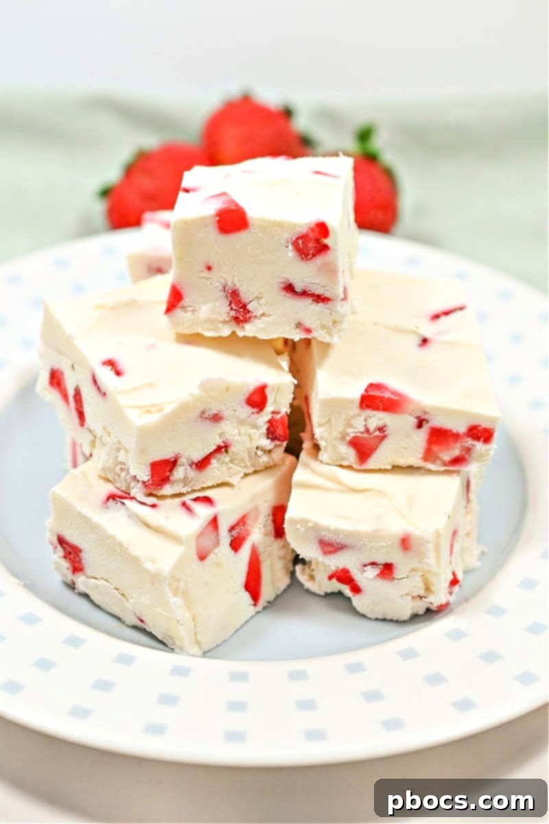 Decadent Keto Strawberry Fudge 5 Individual squares of Keto Strawberry Cream Fudge garnished with fresh strawberries