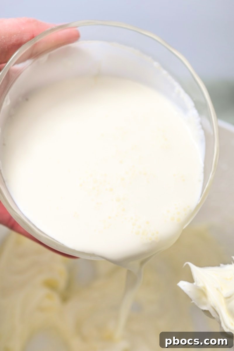 Decadent Keto Strawberry Fudge 10 Adding heavy whipping cream to the fudge mixture