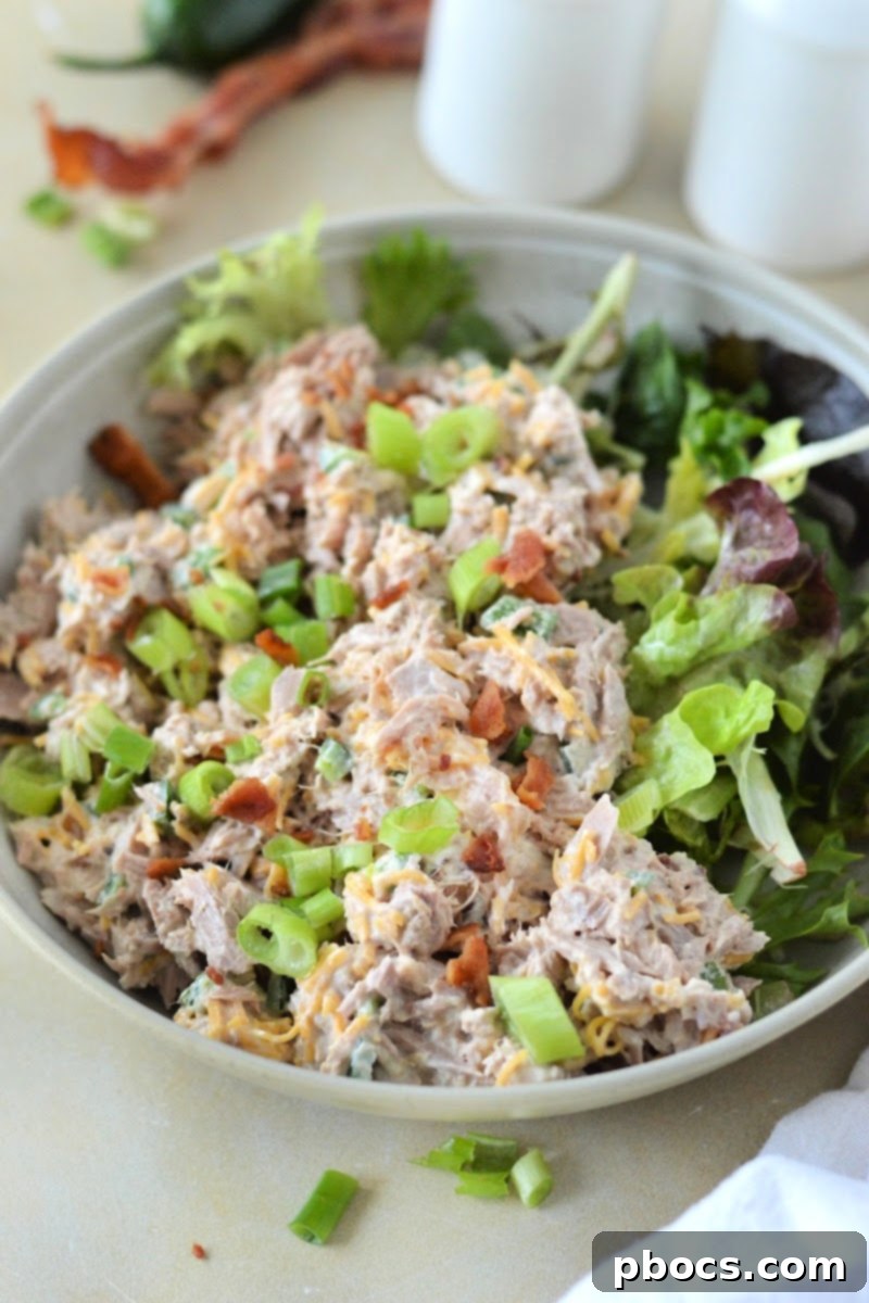 Keto Jalapeno Popper Tuna Salad in a decorative bowl, ready to be served, garnished with fresh herbs