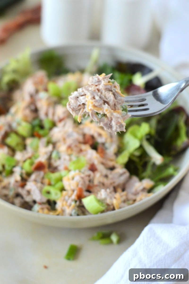 A clear glass container holding Keto Jalapeno Popper Tuna Salad, sealed and ready for refrigerator storage