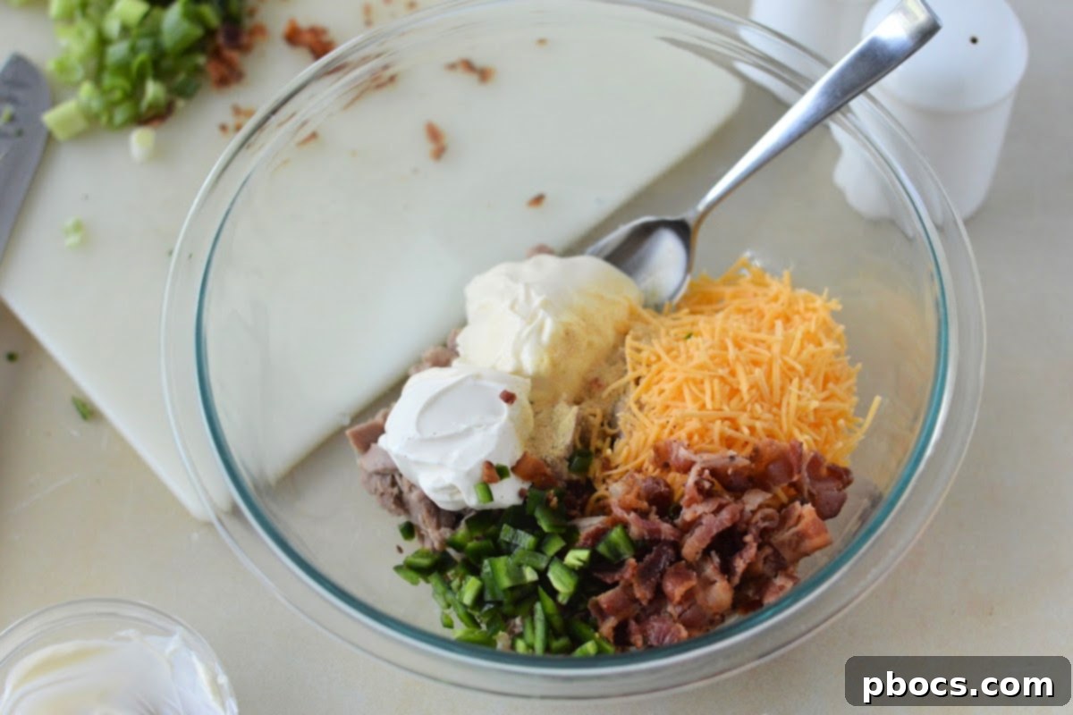 Mixing bowl with Keto Jalapeno Popper Tuna Salad ingredients being combined