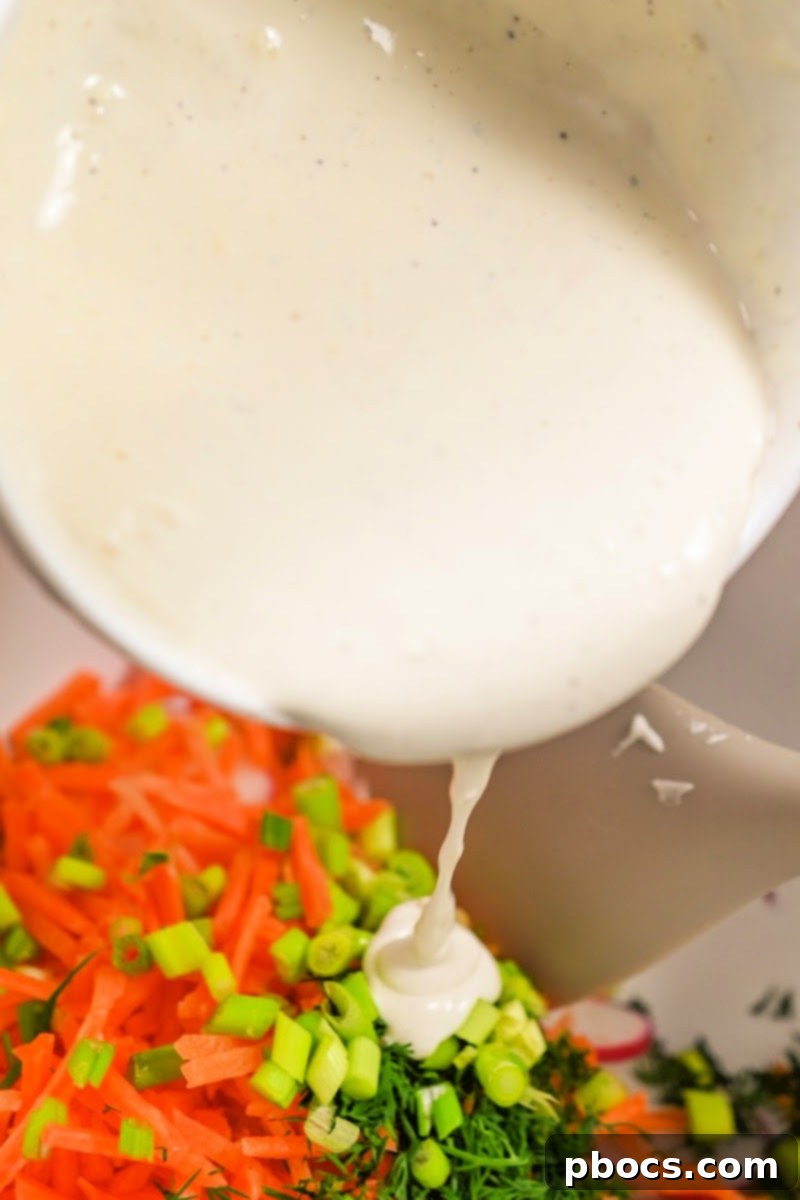 Refreshing Keto Carrot Radish Slaw 12 Pouring dressing over carrot and radish mixture