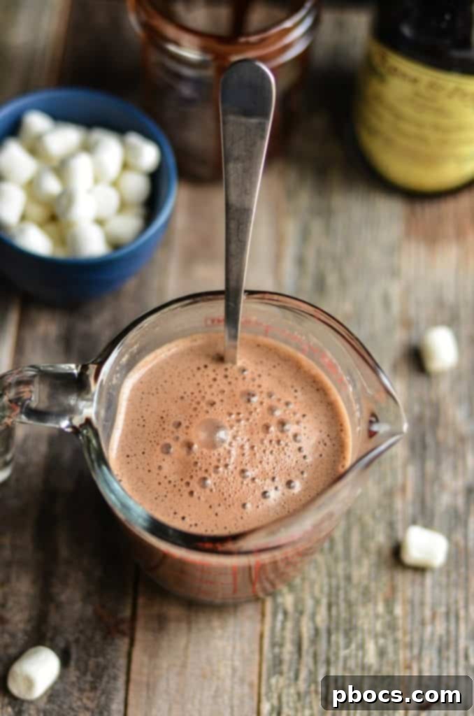 Homemade Bourbon Spiked Hot Chocolate Stirring melted chocolate into hot milk until the mixture is silky smooth.