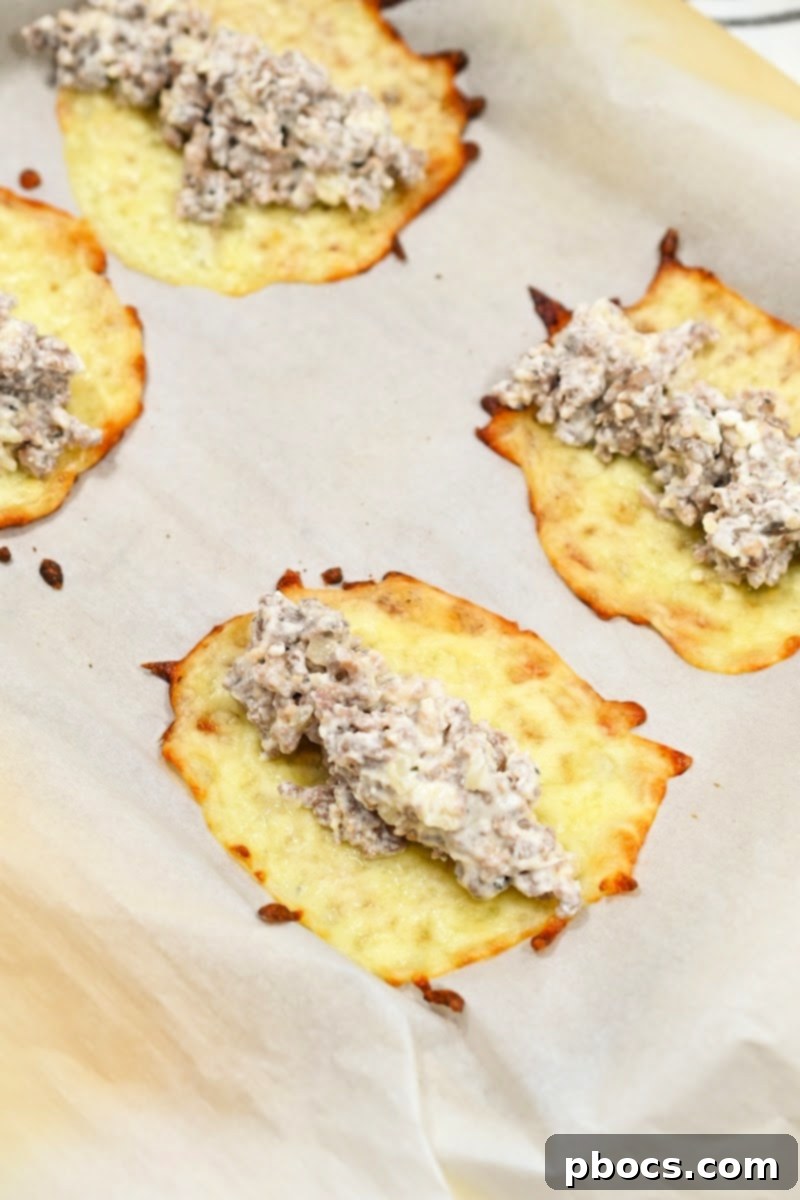 Keto Sausage Lasagna Pinwheels 14 Sausage mixture being placed onto the center of a cheese wrap