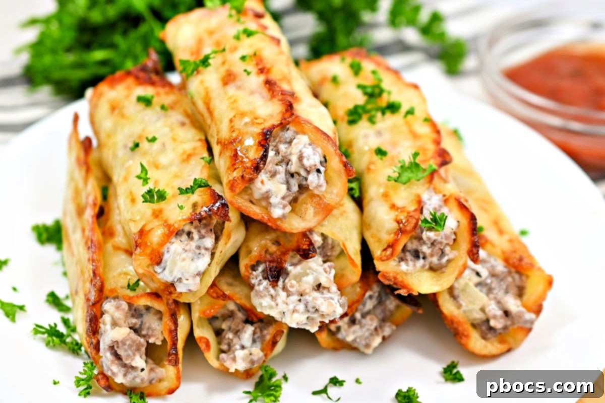 Keto Sausage Lasagna Pinwheels 5 Keto Sausage Lasagna Roll Ups on a baking sheet, showcasing the cheese wraps