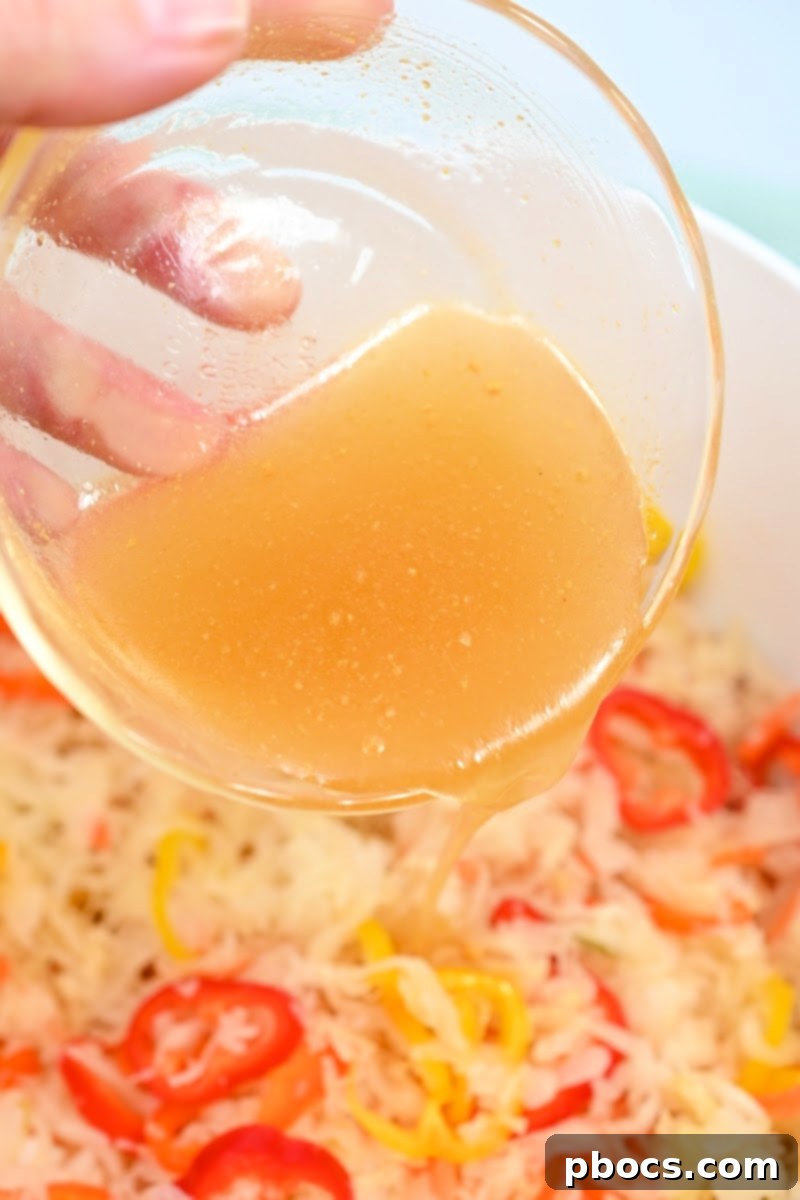 Pouring dressing over sauerkraut salad