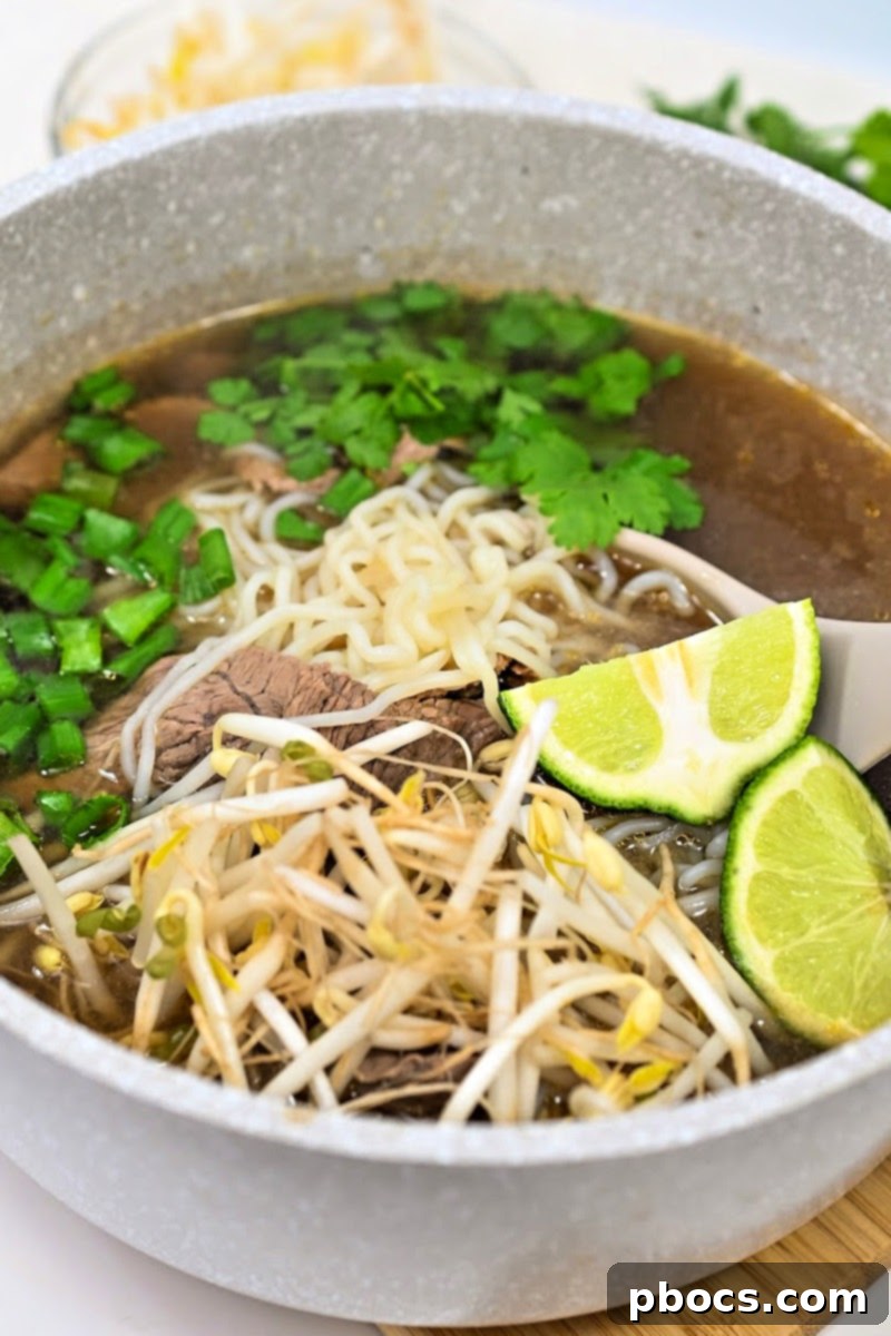 A steaming bowl of Keto Beef Pho, showcasing the rich broth and sliced beef