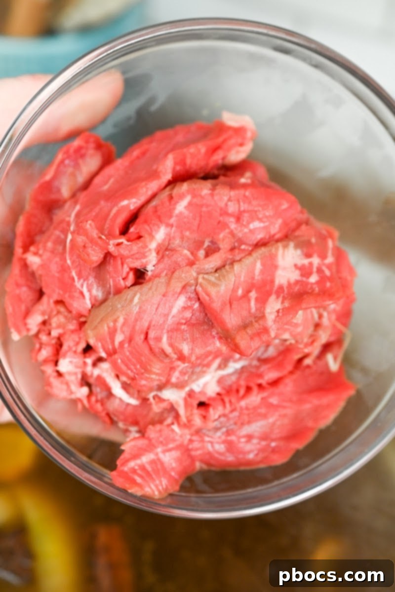 Raw, thinly sliced beef, ready for a delicious Keto Beef Pho