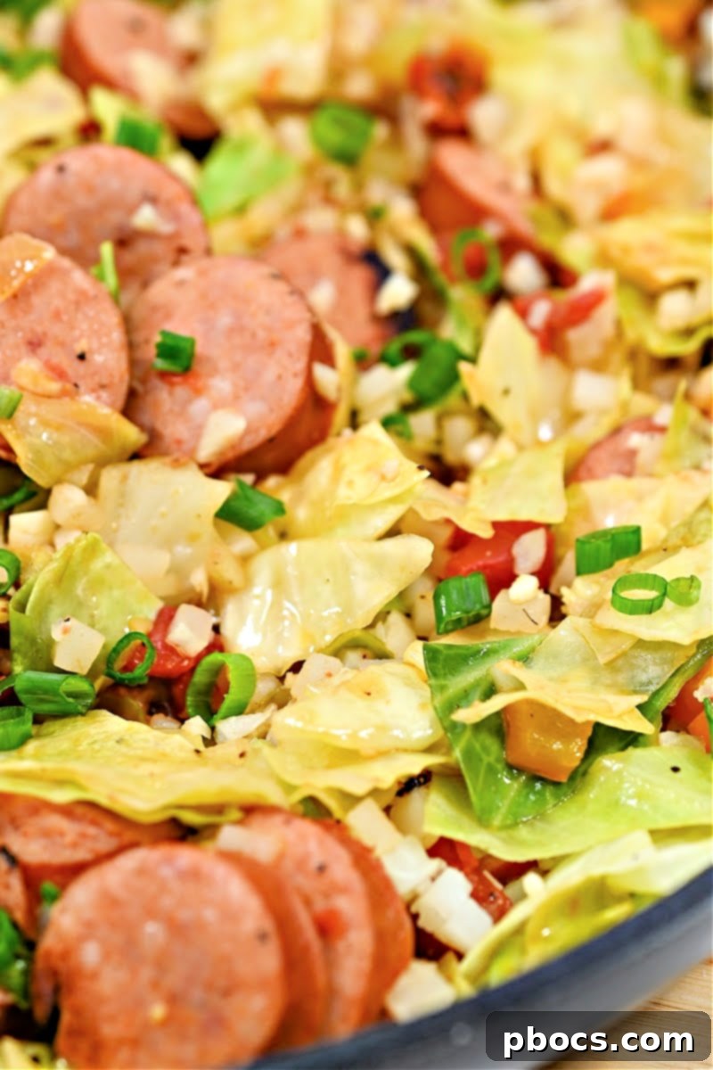 Final Keto Cabbage Jambalaya Skillet garnished with green onions and ready to serve.