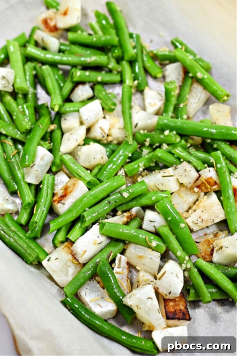 Mixing turnips and green beans with herbs and spices on a baking sheet