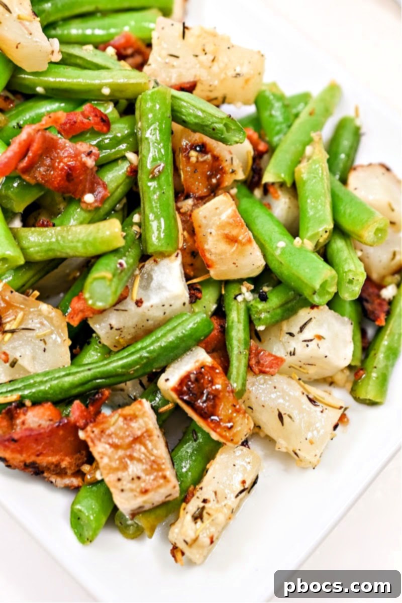 Roasted garlic turnips and green beans on a baking sheet, ready to be served