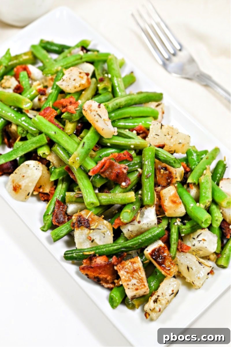 A beautifully plated serving of keto roasted garlic turnips and green beans with bacon