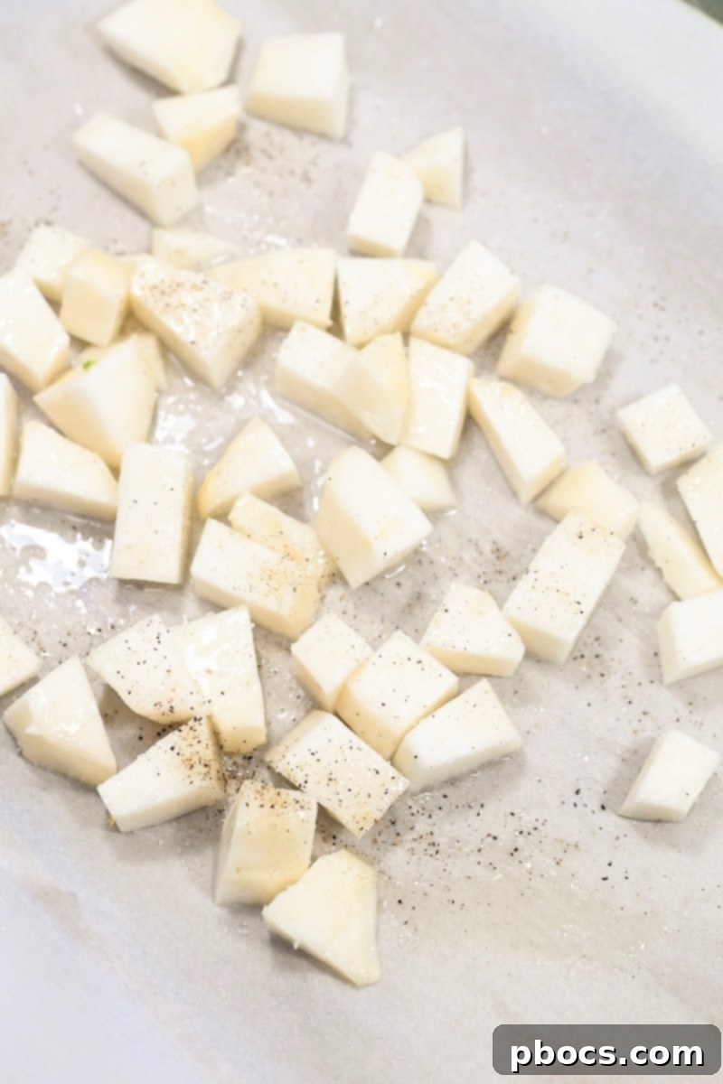 Turnips roasting on a parchment-lined baking sheet