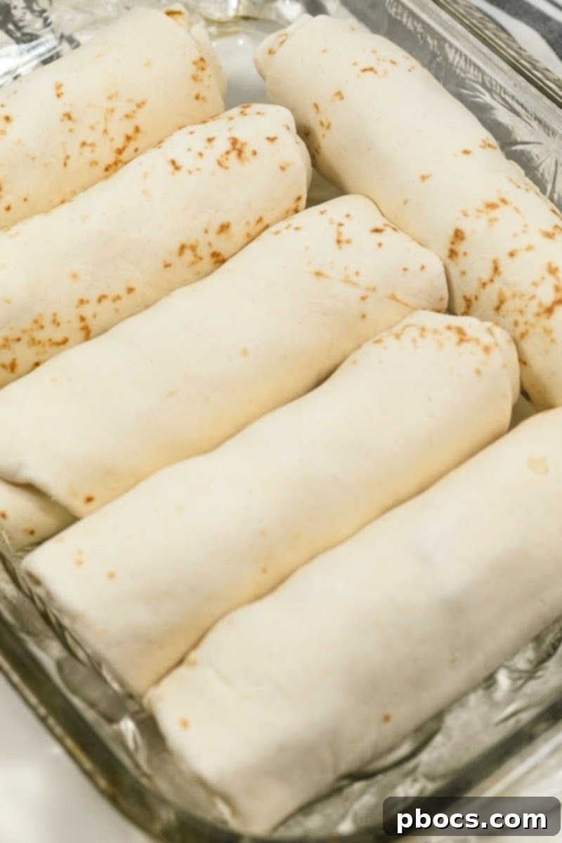 Unbaked Keto Crack Chicken Enchiladas placed in a baking dish