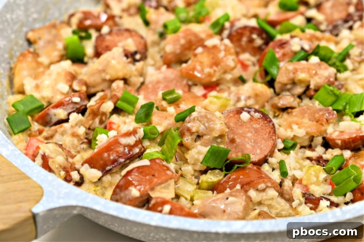 Finished Keto Sausage and Chicken Cajun Alfredo Skillet garnished with green onions