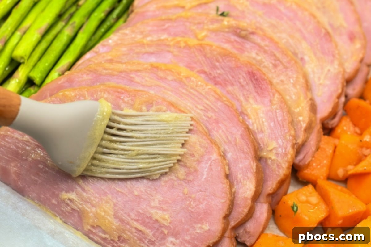 Adding melted butter and sugar-free honey glaze to the ham slices