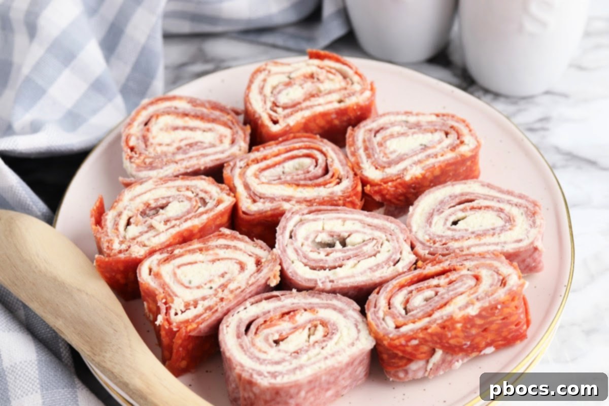A plate of freshly sliced Keto Boursin Roll Ups, ready to be served as an appetizer.