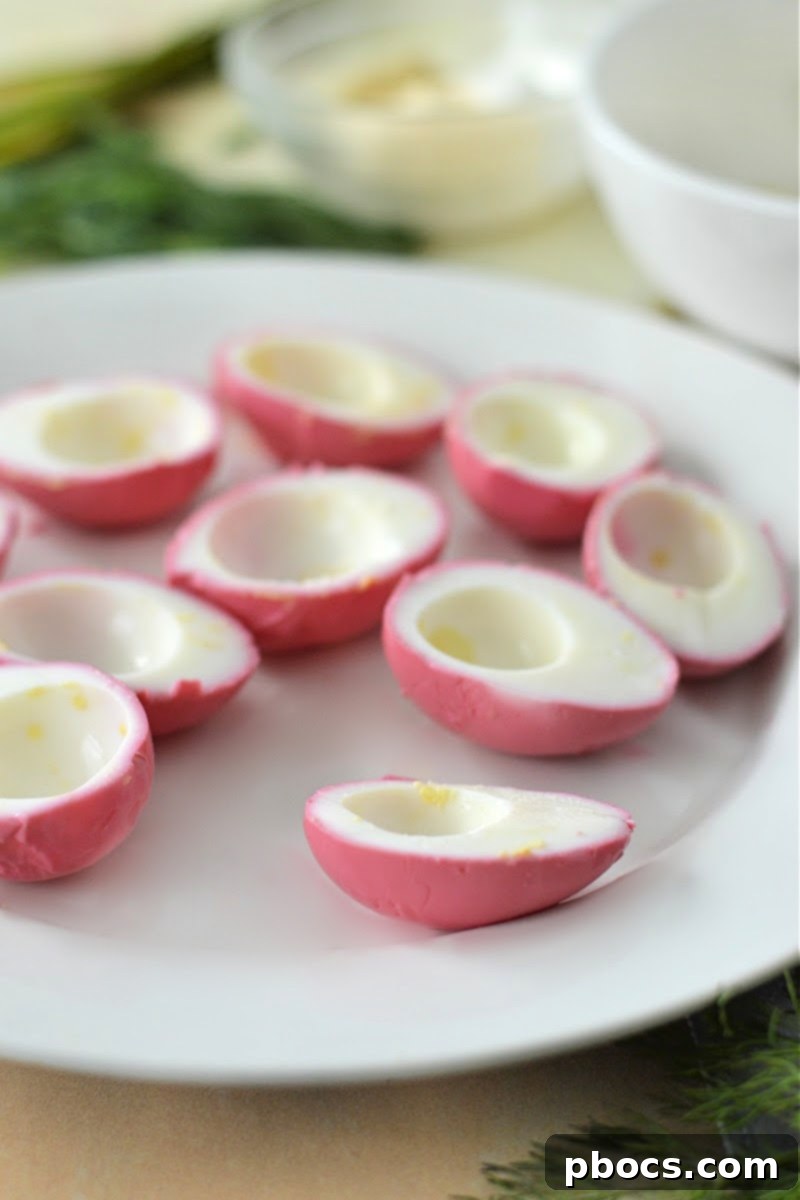 Peeled hard-boiled egg whites soaking in the cooled beet mixture