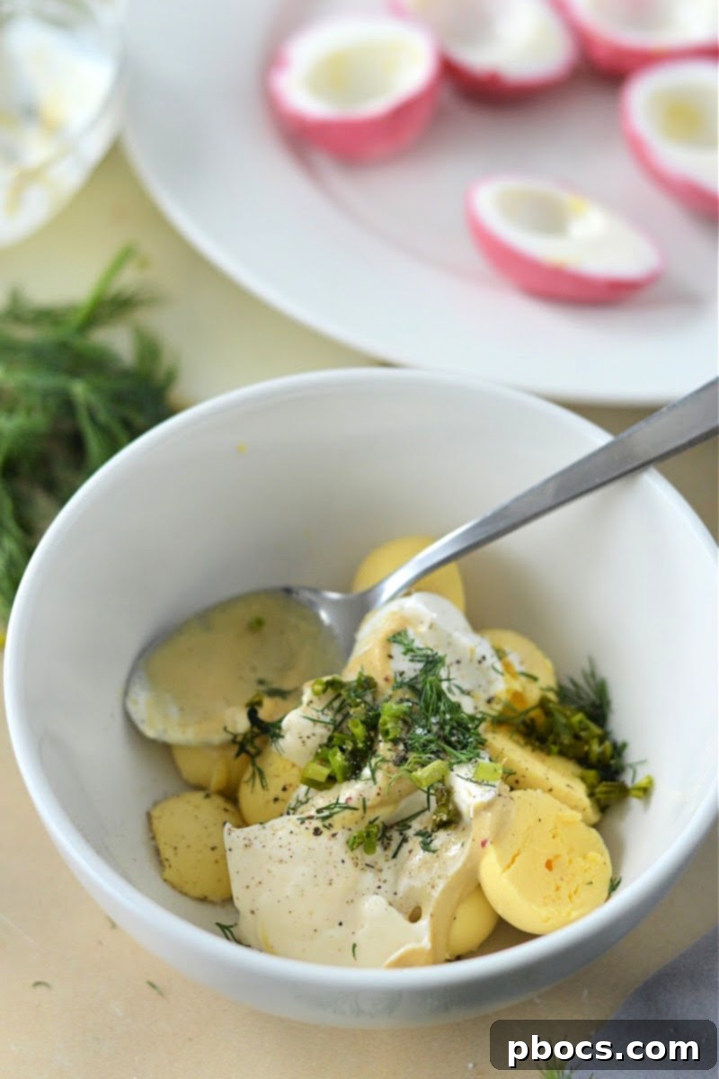 Mixing the egg yolks with filling ingredients in a bowl