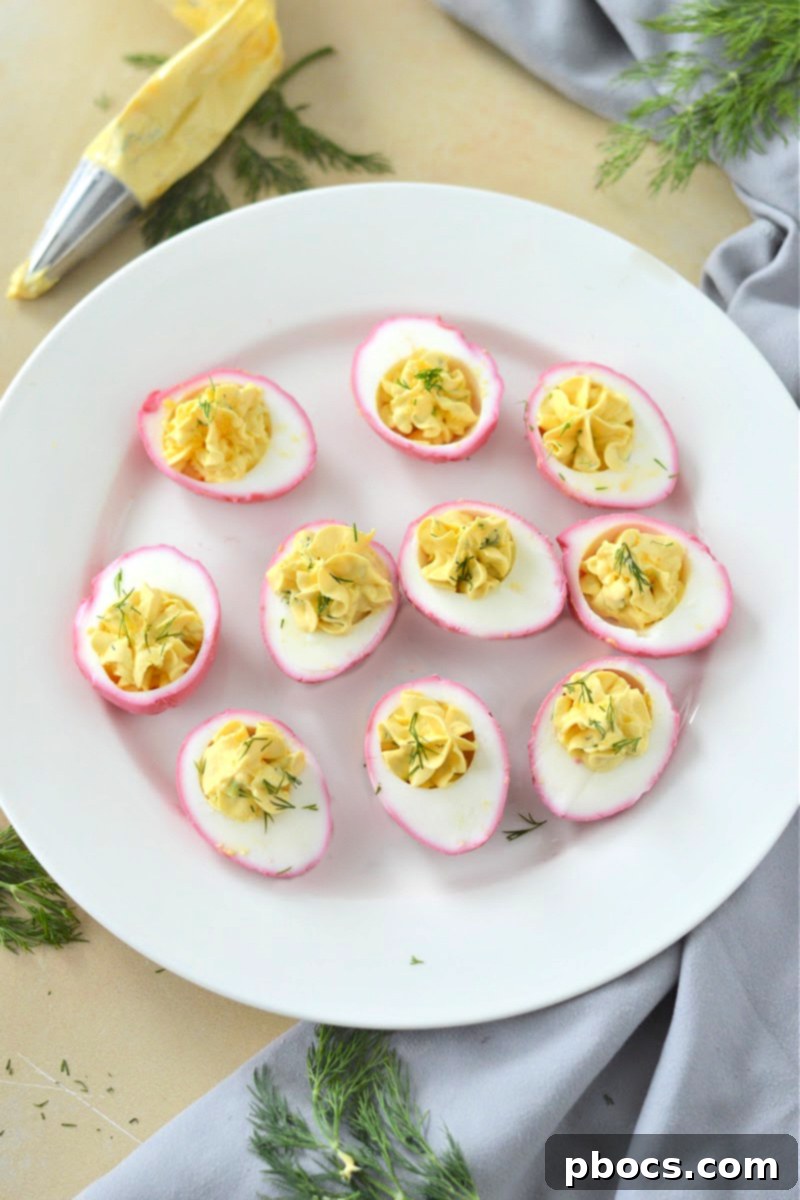 Preparing the flavorful filling for Keto Pickled Deviled Eggs with fresh herbs