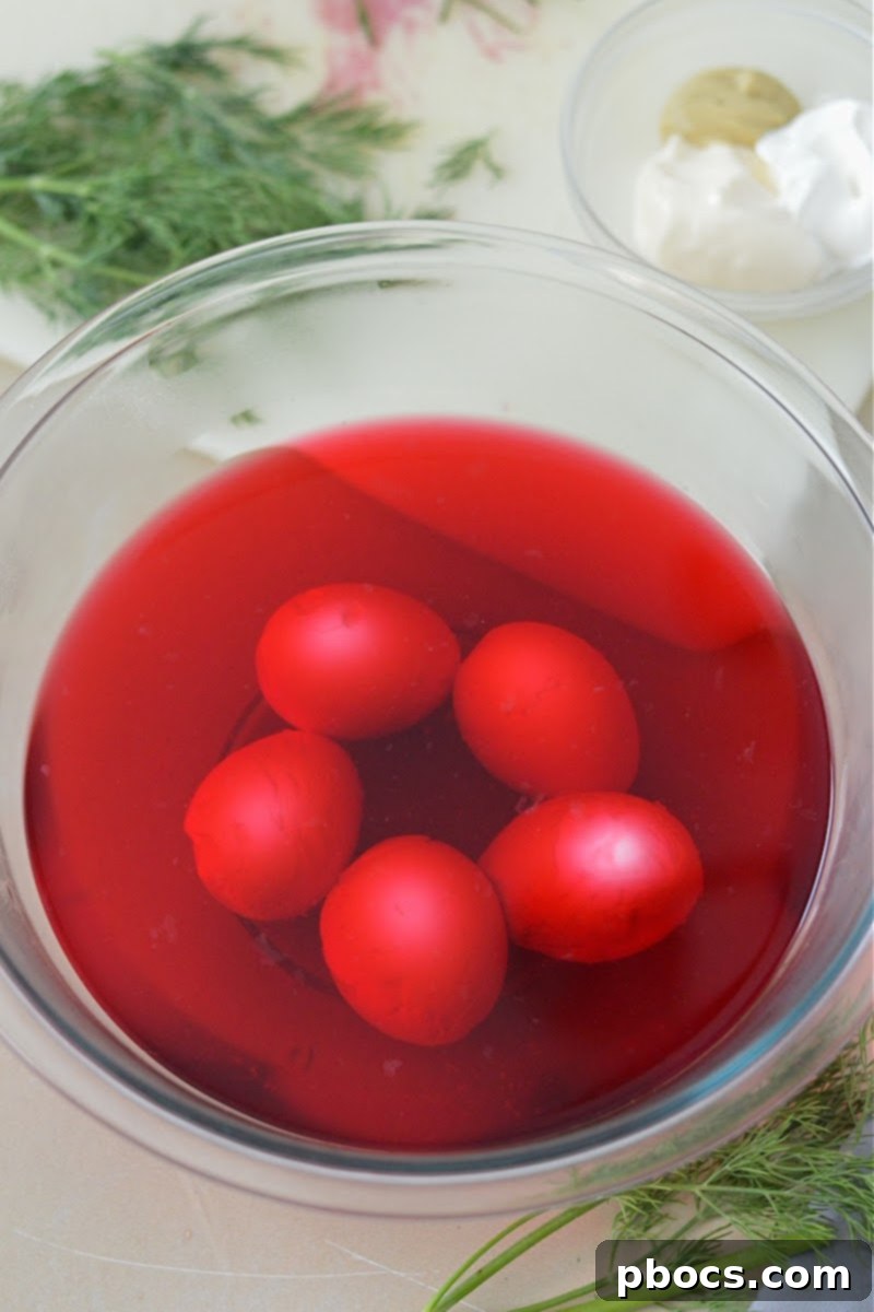 Hard Boiled Eggs simmering in a beet and water mixture