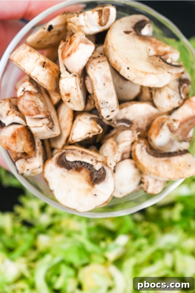 Adding mushrooms to the skillet after Brussels sprouts