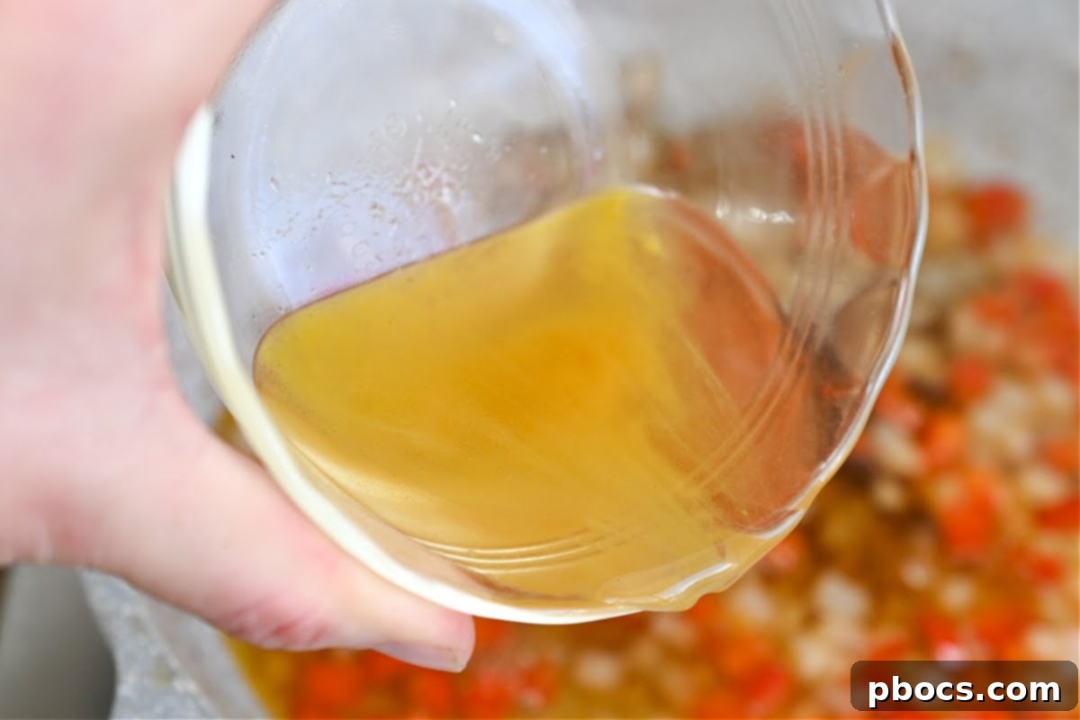 Adding Chicken Broth to Sautéed Vegetables