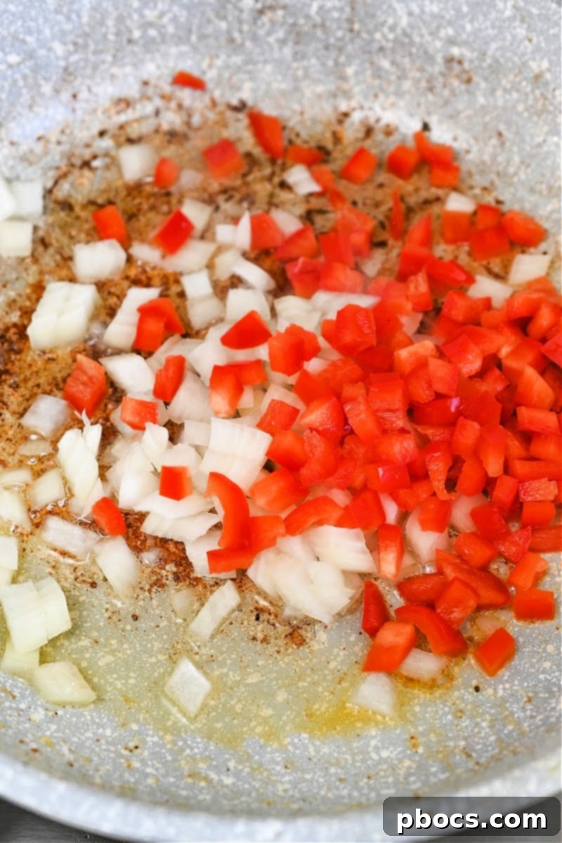 Sautéing Onions and Red Bell Pepper for Cabbage Dish